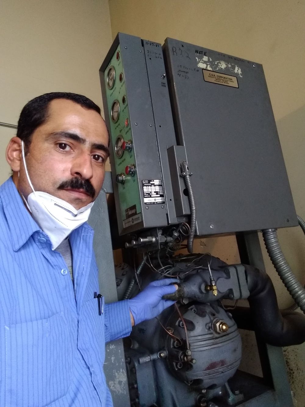 Hanna Afram repairing a condenser unit